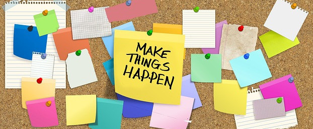 Picture of sticky notes with a more prominent notice saying to make things happen
