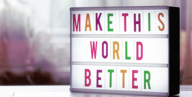 A sign saying make this world better