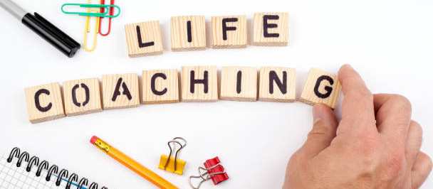 Small square blocks spelling out life coaching